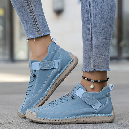 Light blue slip-on trainers with lace-up front and ankle strap, stitched rubber sole