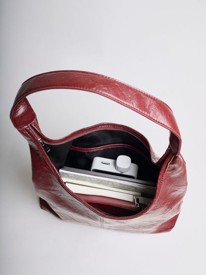 Burgundy distressed vegan leather tote interior with zip pocket and top opening