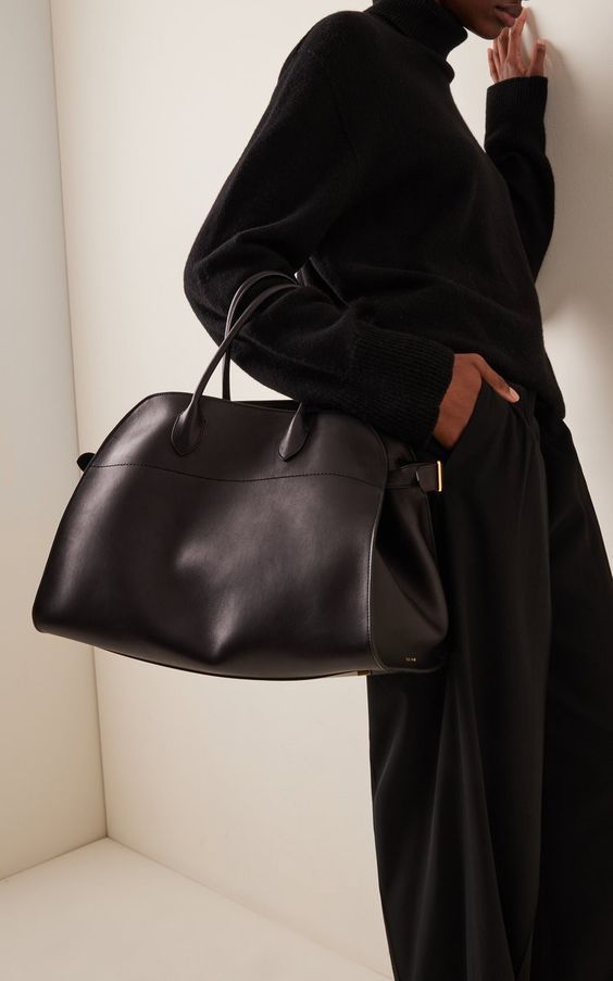Black suede handbag with top handles and center seam detail