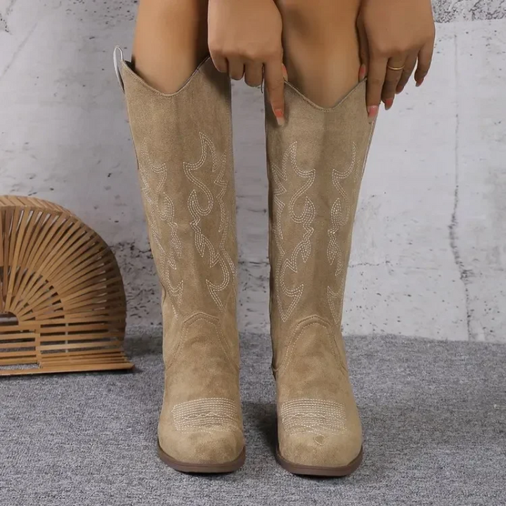 Knee-high western boots in beige suede with embroidered swirl pattern and low block heel