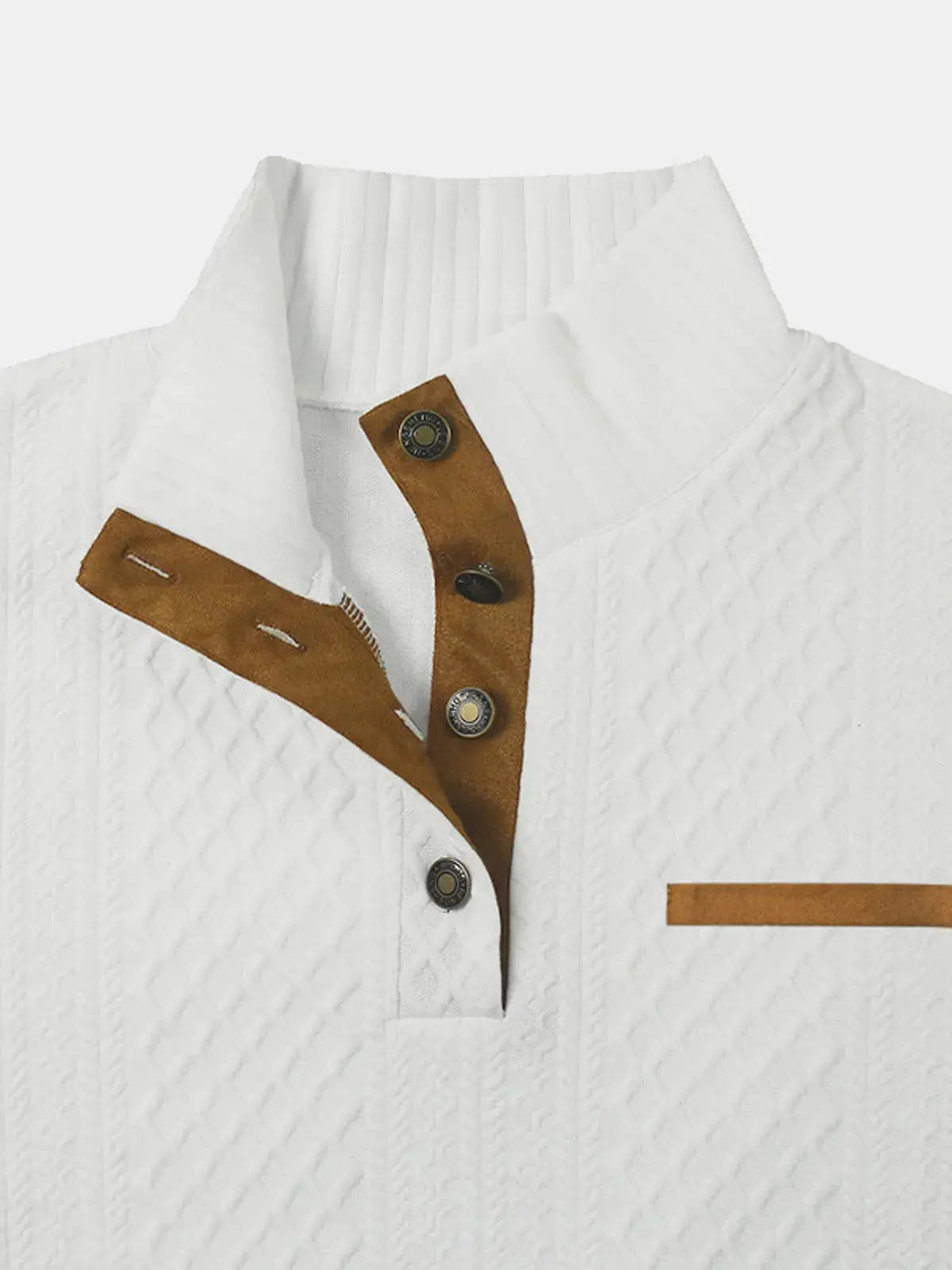 White cable-knit pullover close-up with brown button placket and decorative patch accents