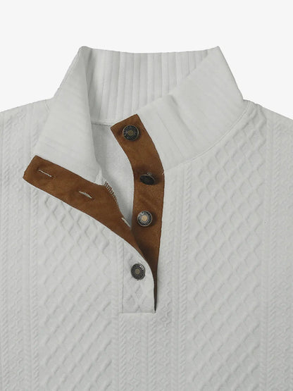 White cable knit quarter-button pullover with brown button placket and stand collar