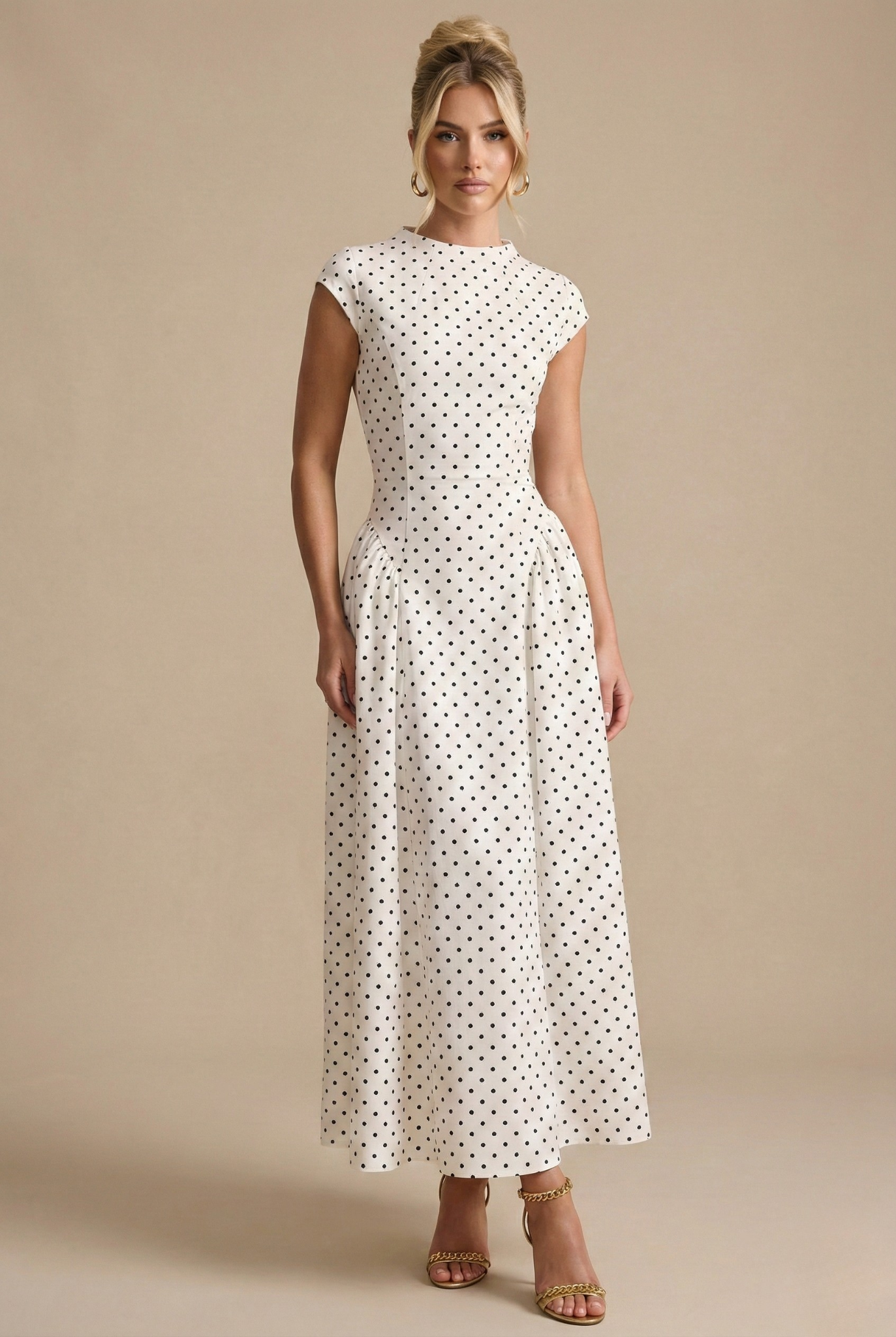 White polka dot maxi dress with high neckline, cap sleeves, and fitted waist