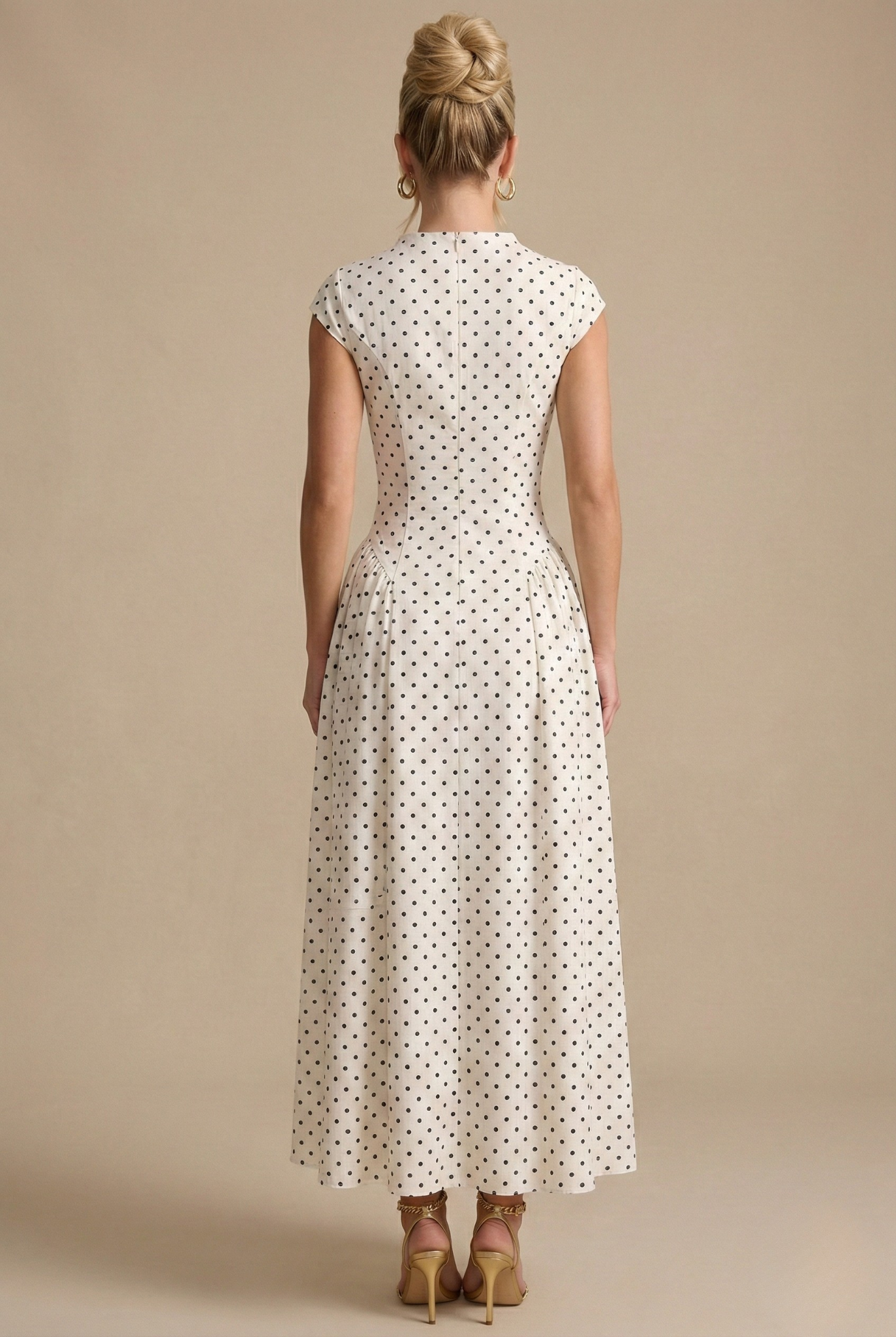 White polka dot maxi dress, back view with high neck and gathered waist