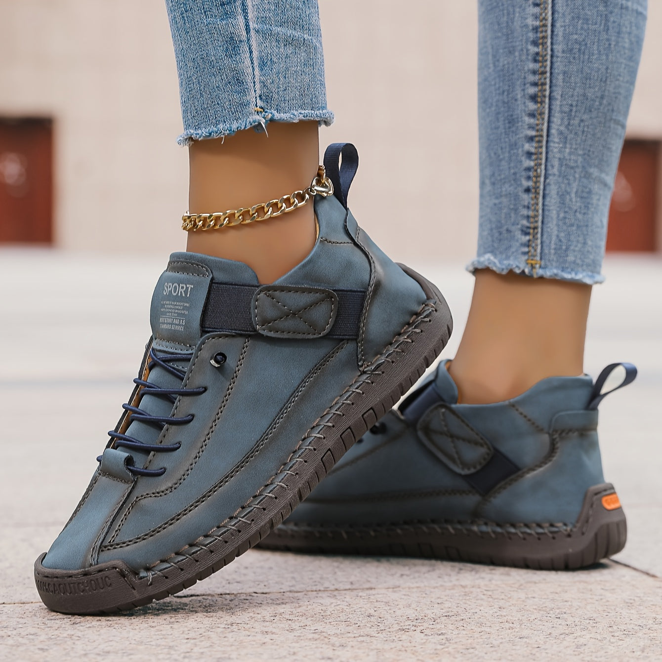 Blue slip-on trainers with lace-up front and ankle strap, gold chain detail