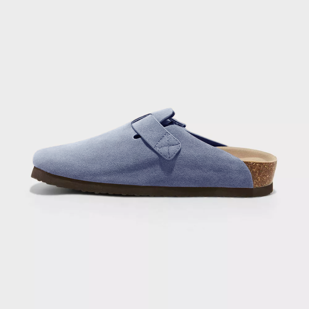 Light blue suede clog side view with adjustable buckle strap and textured sole