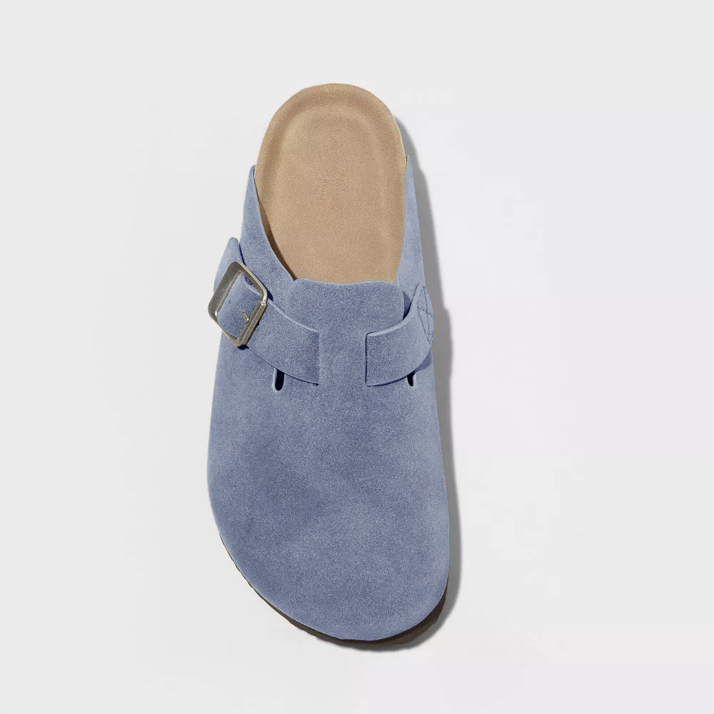 Light blue suede clog front view with adjustable buckle strap and tan insole