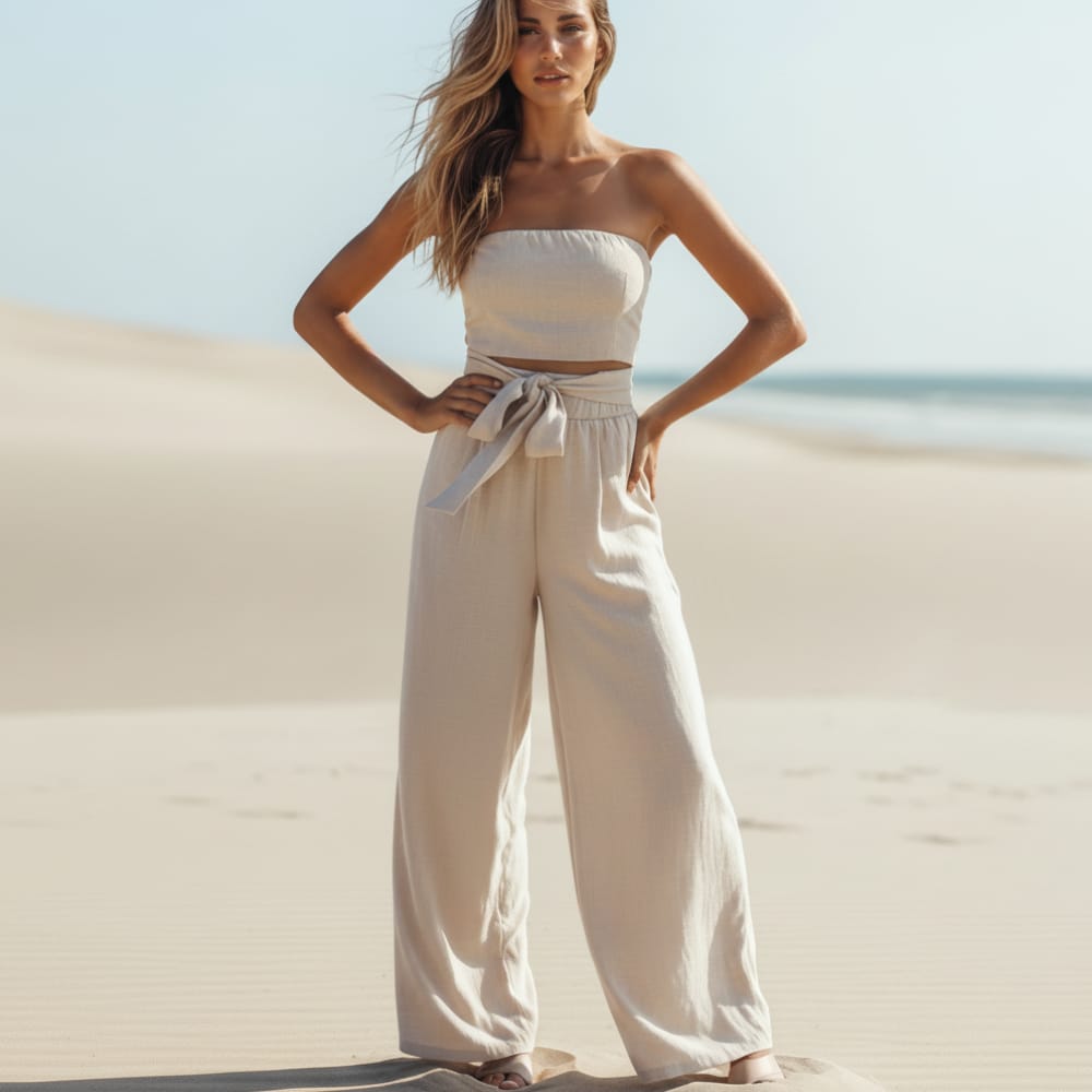 White strapless wide-leg jumpsuit with bow tie waist and wide trousers