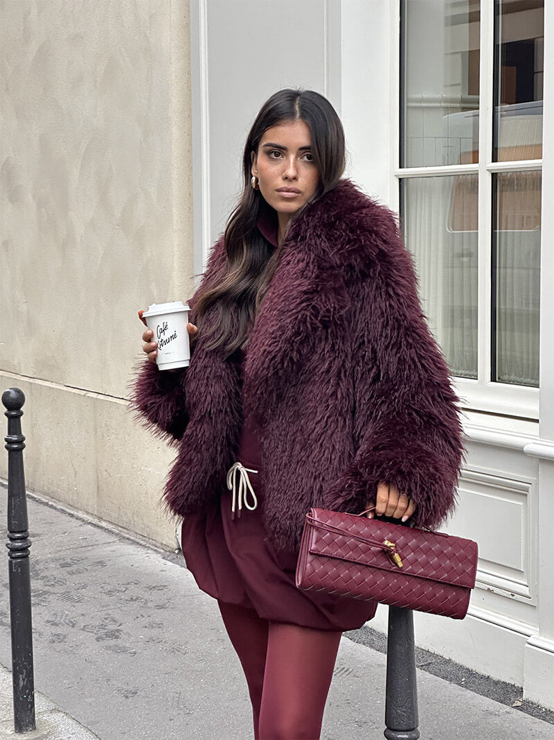 Burgundy woven vegan leather clutch with gold clasp and top handle