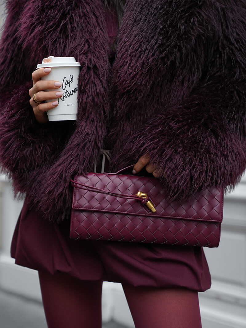 Burgundy woven vegan leather clutch with gold clasp and top handle