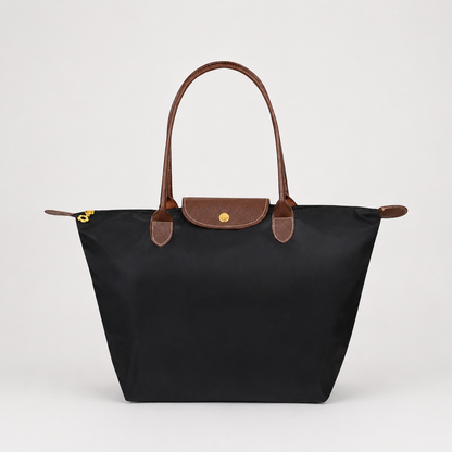 Structured shoulder tote bag with top handles, front flap, and gold clasp, dark black