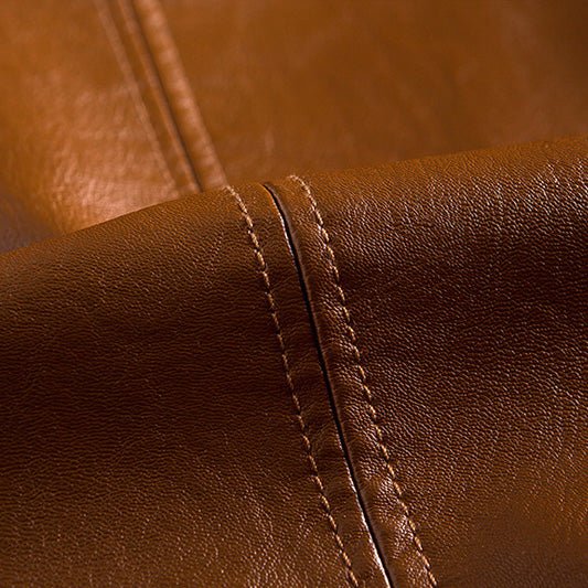 Cognac brown leather jacket close-up showing stitched seams and textured grain