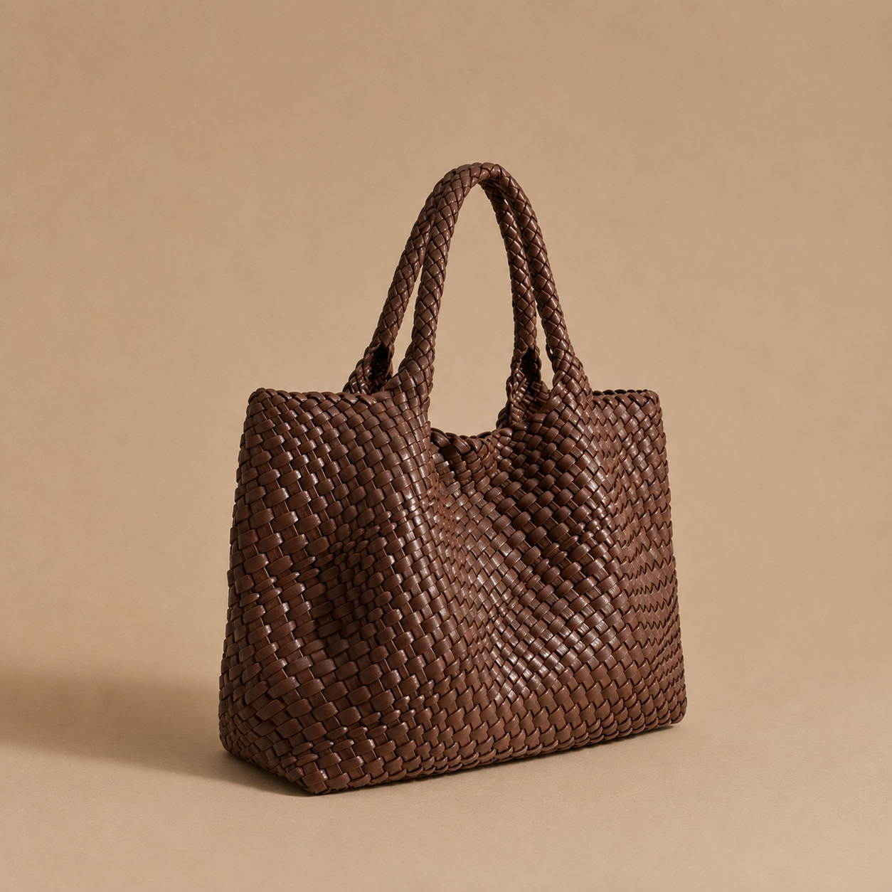 Womens woven tote bag with top handles, coffee brown woven texture.
