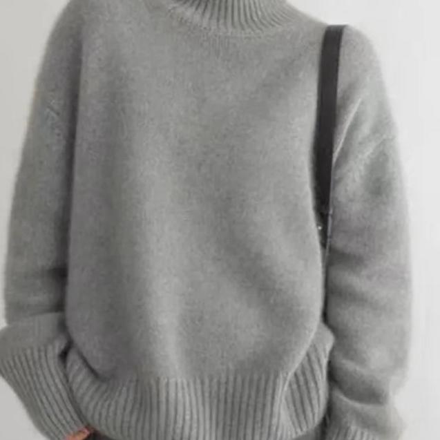 Grey roll-neck cashmere jumper close-up, ribbed hem and knit texture