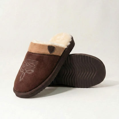 Cowboy slippers with dark brown suede, white faux-fur trim, and patterned toe stitching.