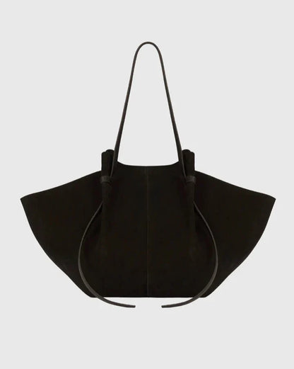 Black suede tote bag with long handles and drawstring top