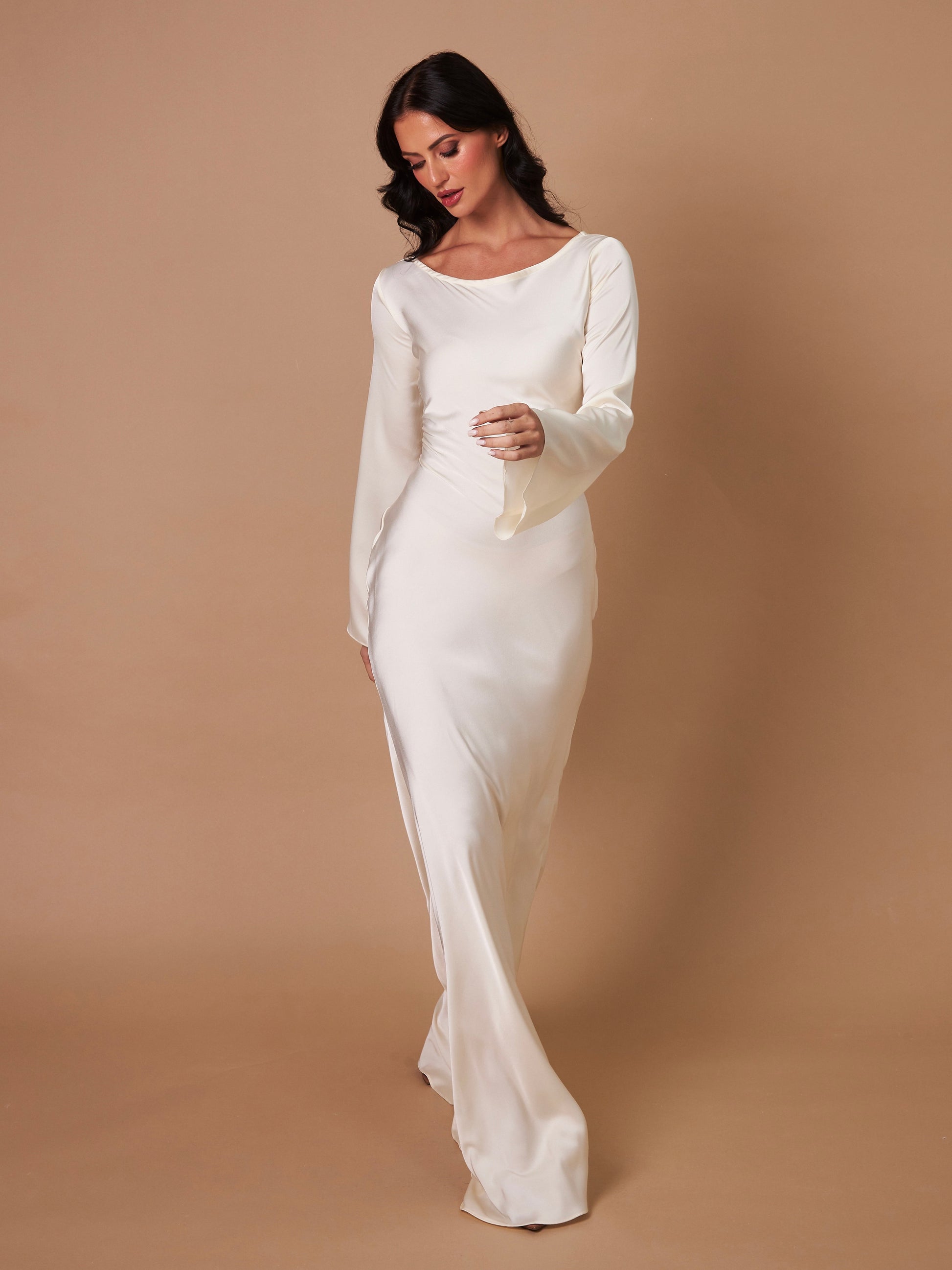Cream long-sleeve maxi dress, three-quarter view, gathered seams at waist