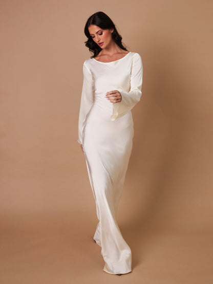 Cream long-sleeve maxi dress, three-quarter view, gathered seams at waist