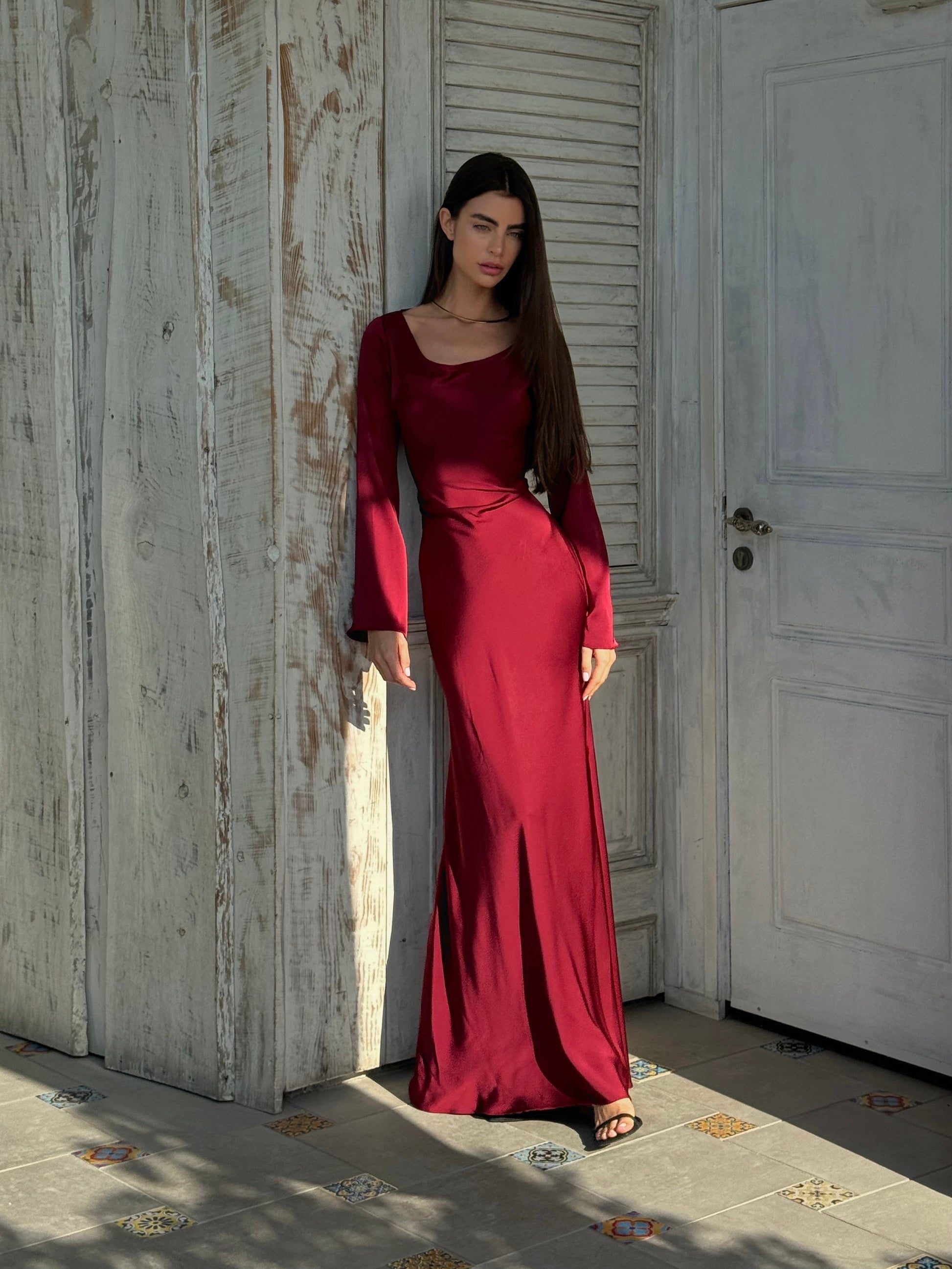 Red long-sleeved maxi dress with square neckline and fitted waist