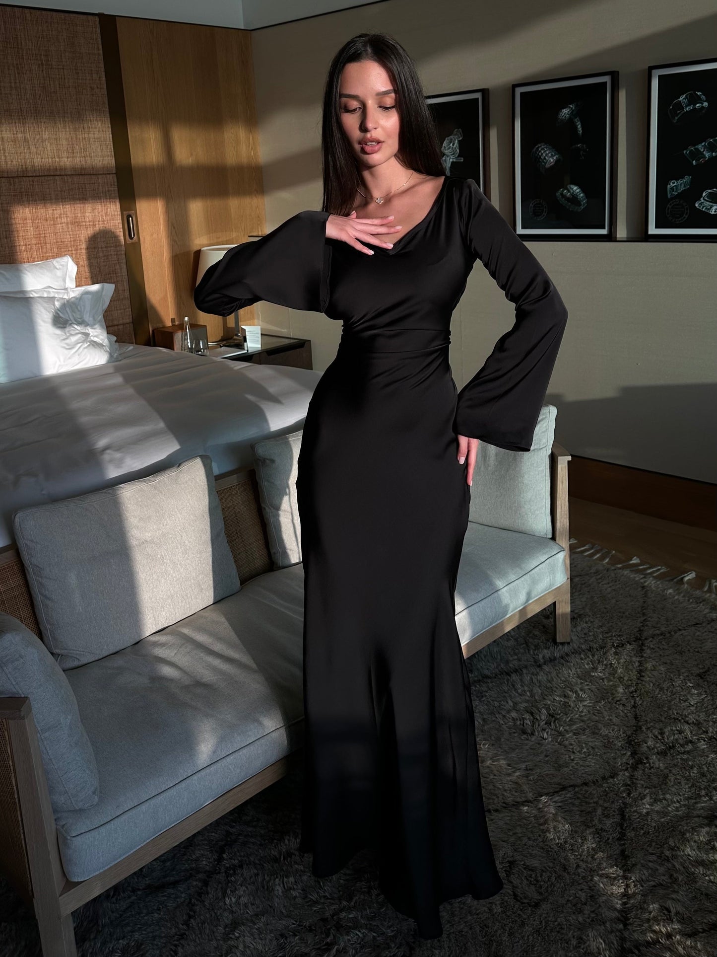 Black long-sleeved maxi dress with fitted waist and soft V neckline