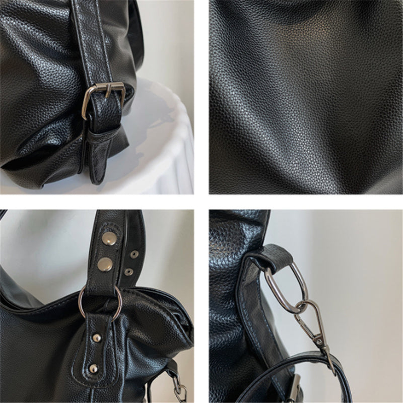 Black vegan leather handbag close-up of strap hardware, grommets, and textured finish
