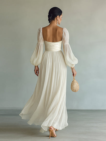 White chiffon maxi dress with open back, gathered waist and long puff sleeves