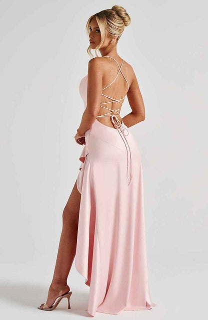 Light pink maxi dress with crisscross open back and ruffle-trimmed skirt.