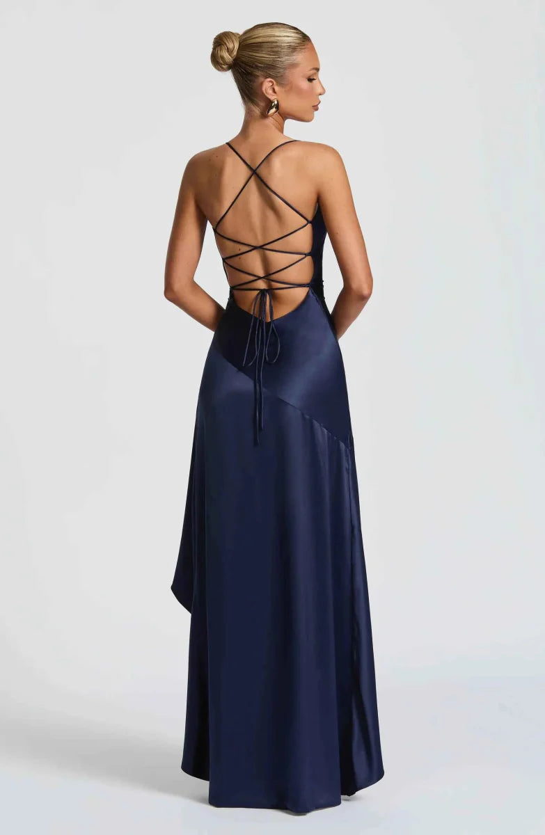 Navy maxi dress with crisscross open back and flowing ruffle-trimmed hem.
