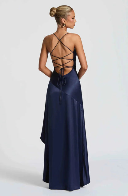 Navy maxi dress with crisscross open back and flowing ruffle-trimmed hem.