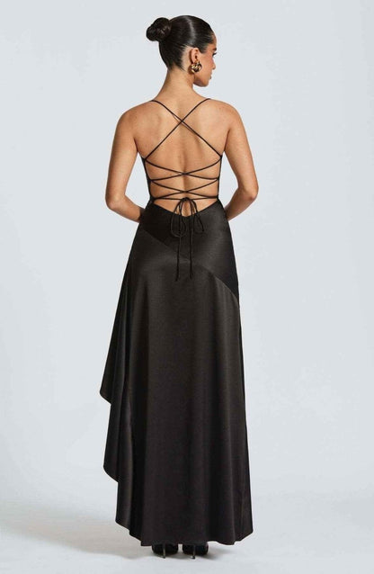 Black maxi dress with crisscross open back and long ruffle-trimmed hem.