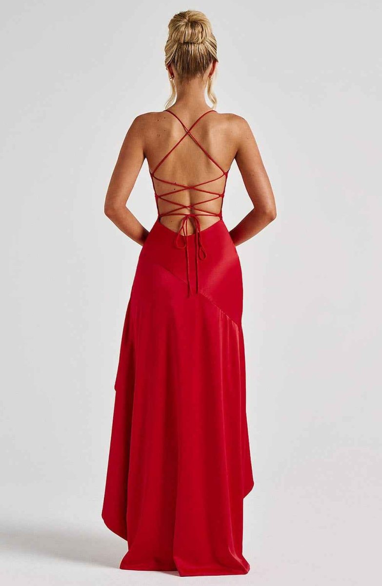 Red open-back maxi dress with crisscross lace-up straps and flowing skirt
