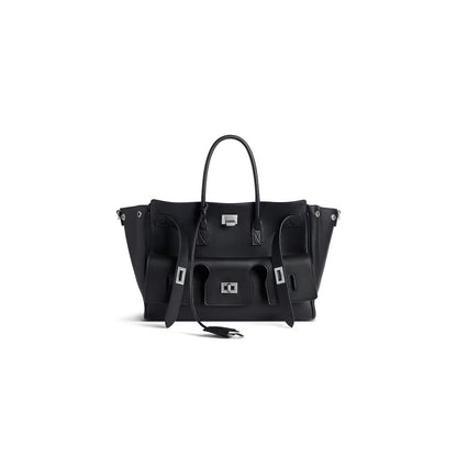 Black structured handbag with top handles, side compartments, and gold-tone hardware
