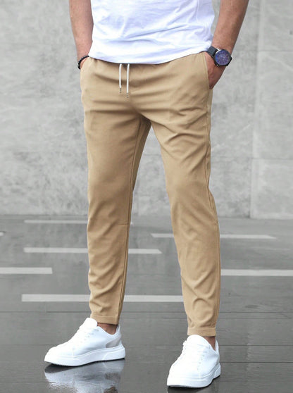 Mens khaki drawstring jogger pants with tapered fit and ankle cuffs