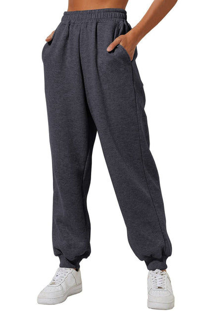 Dark gray sweatpants with elastic waistband, drawstring, and cuffed ankle hems.