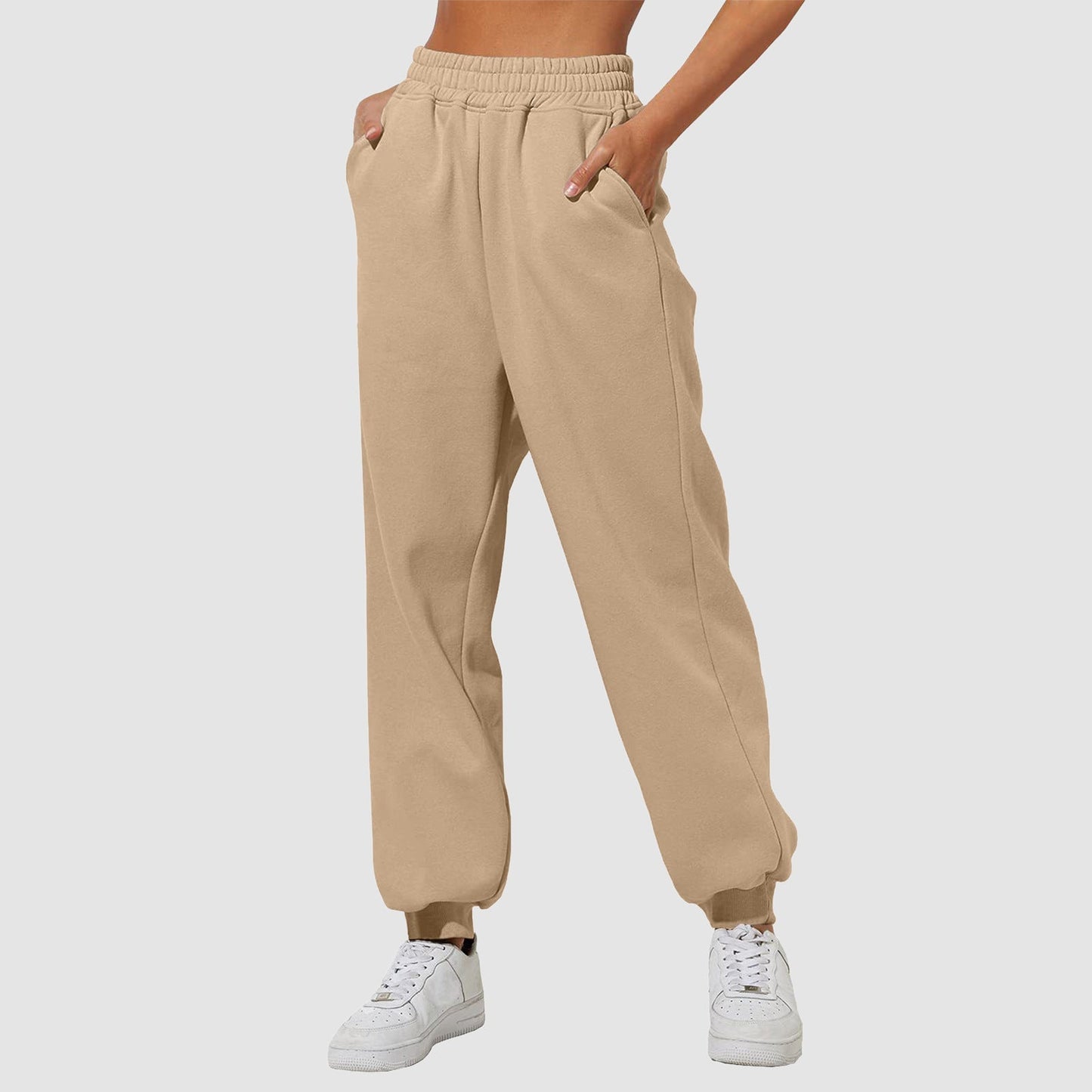 Beige sweatpants with elastic waistband, drawstring, and cuffed ankle hems.