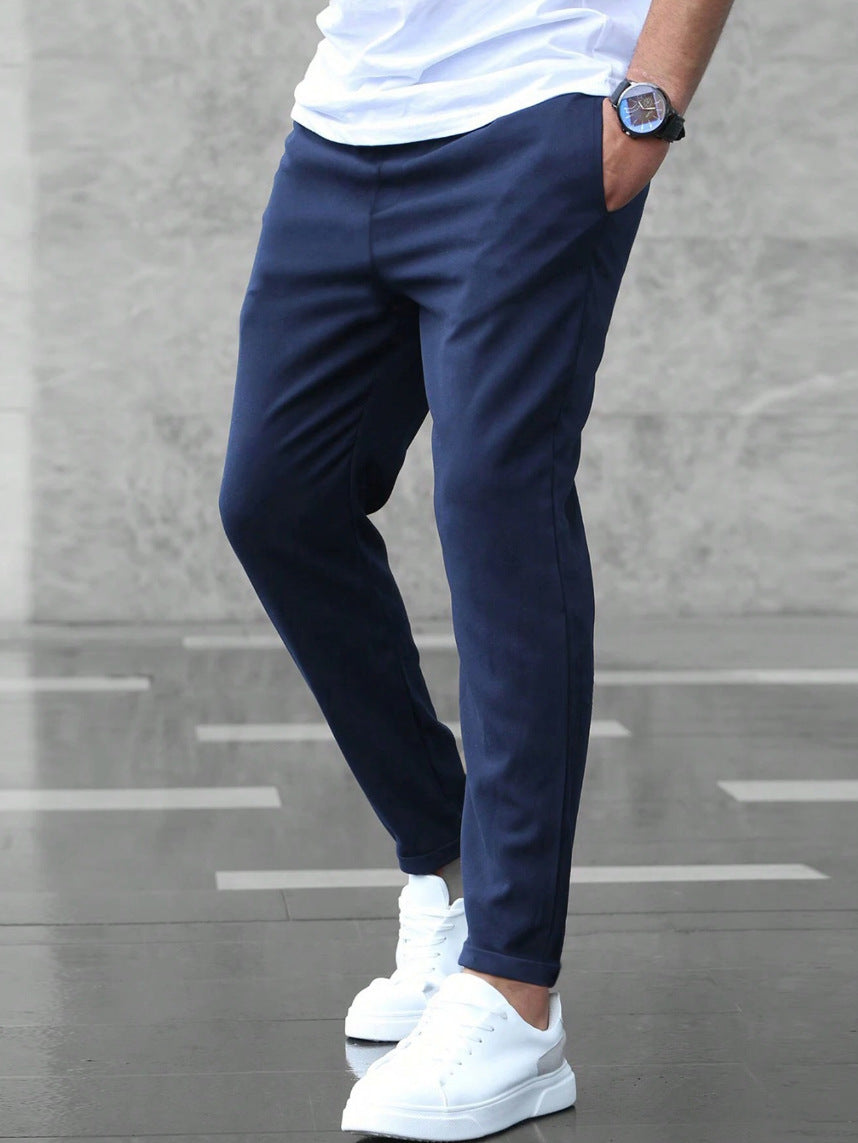 Mens navy drawstring jogger pants with tapered legs and ankle cuffs