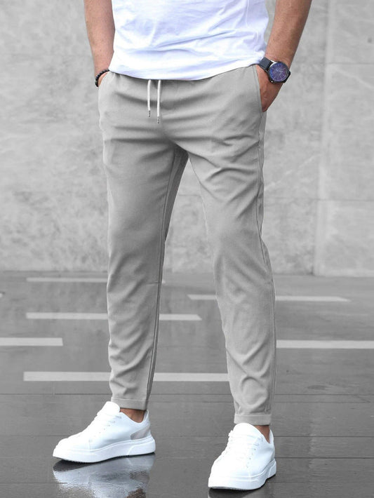 Mens gray drawstring jogger pants with tapered fit and ankle cuffs
