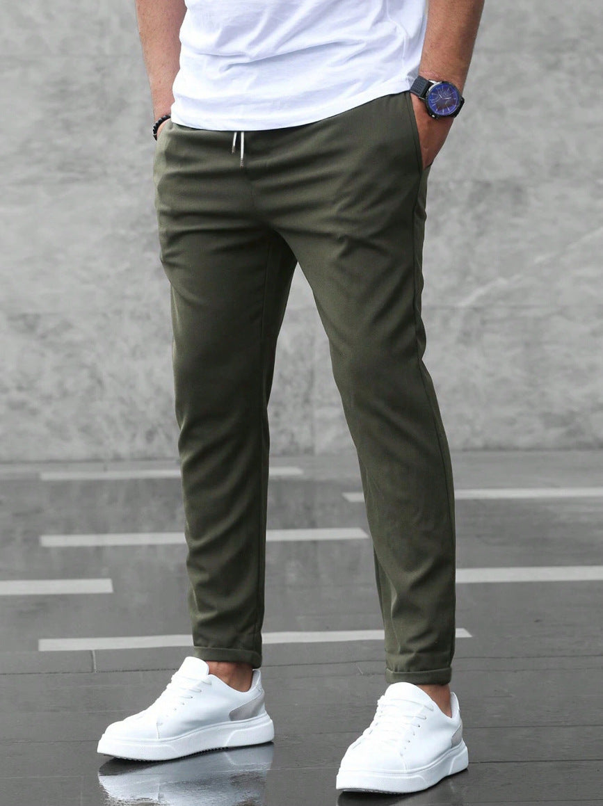 Mens olive green drawstring jogger pants with tapered legs and ankle cuffs