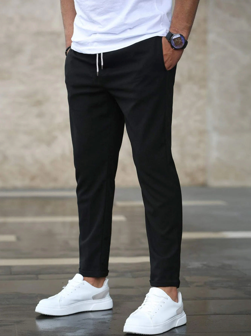 Mens black drawstring jogger pants with tapered fit and ankle cuffs