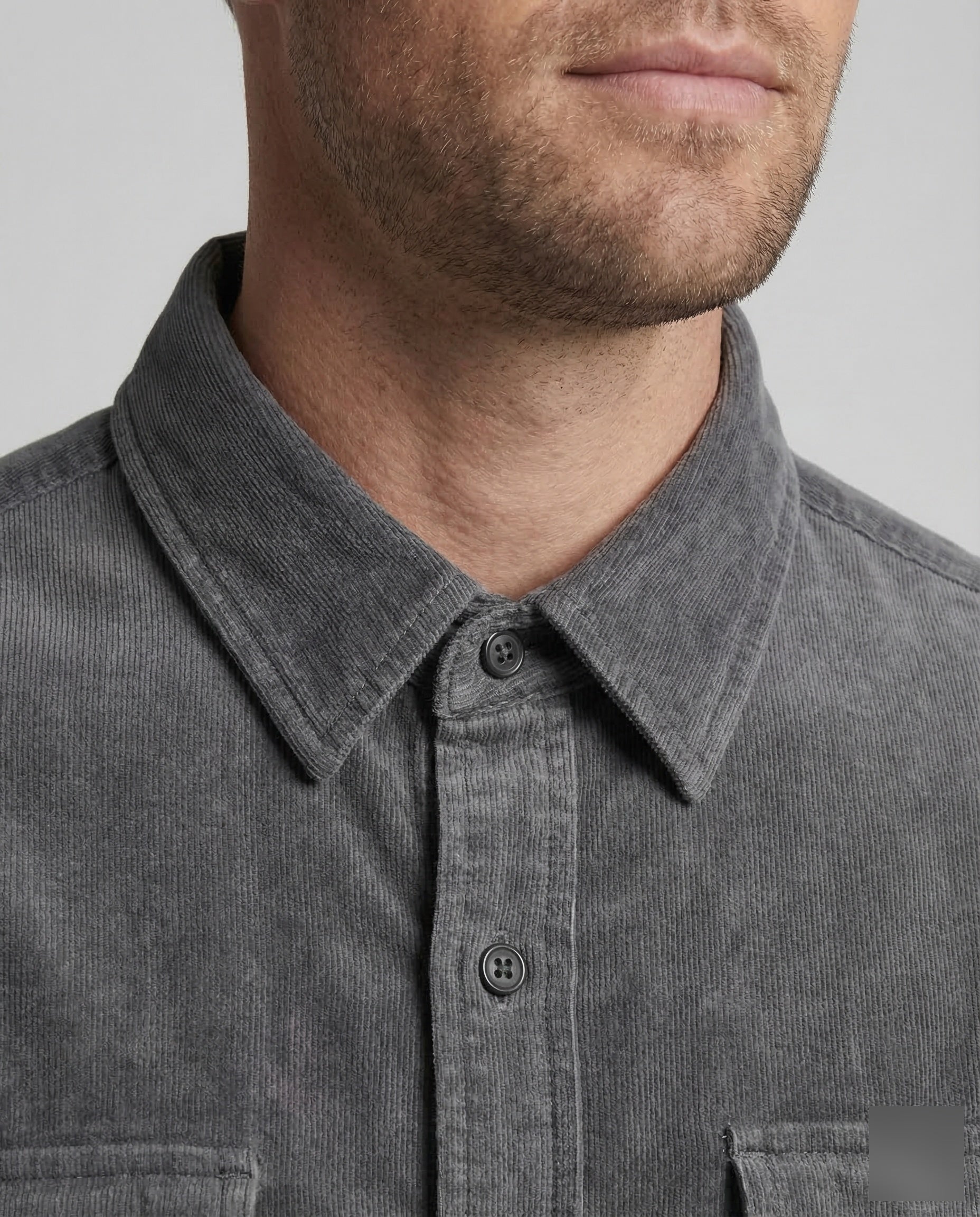 Grey corduroy utility shirt close-up: buttoned collar and front placket with two buttons