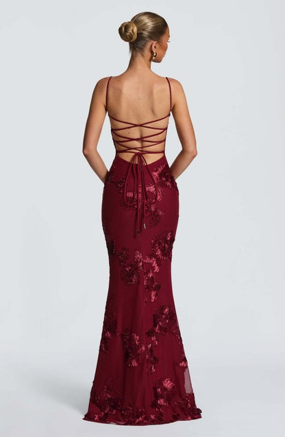 Red lace maxi dress with crisscross open back and lace-up ribbon detail.