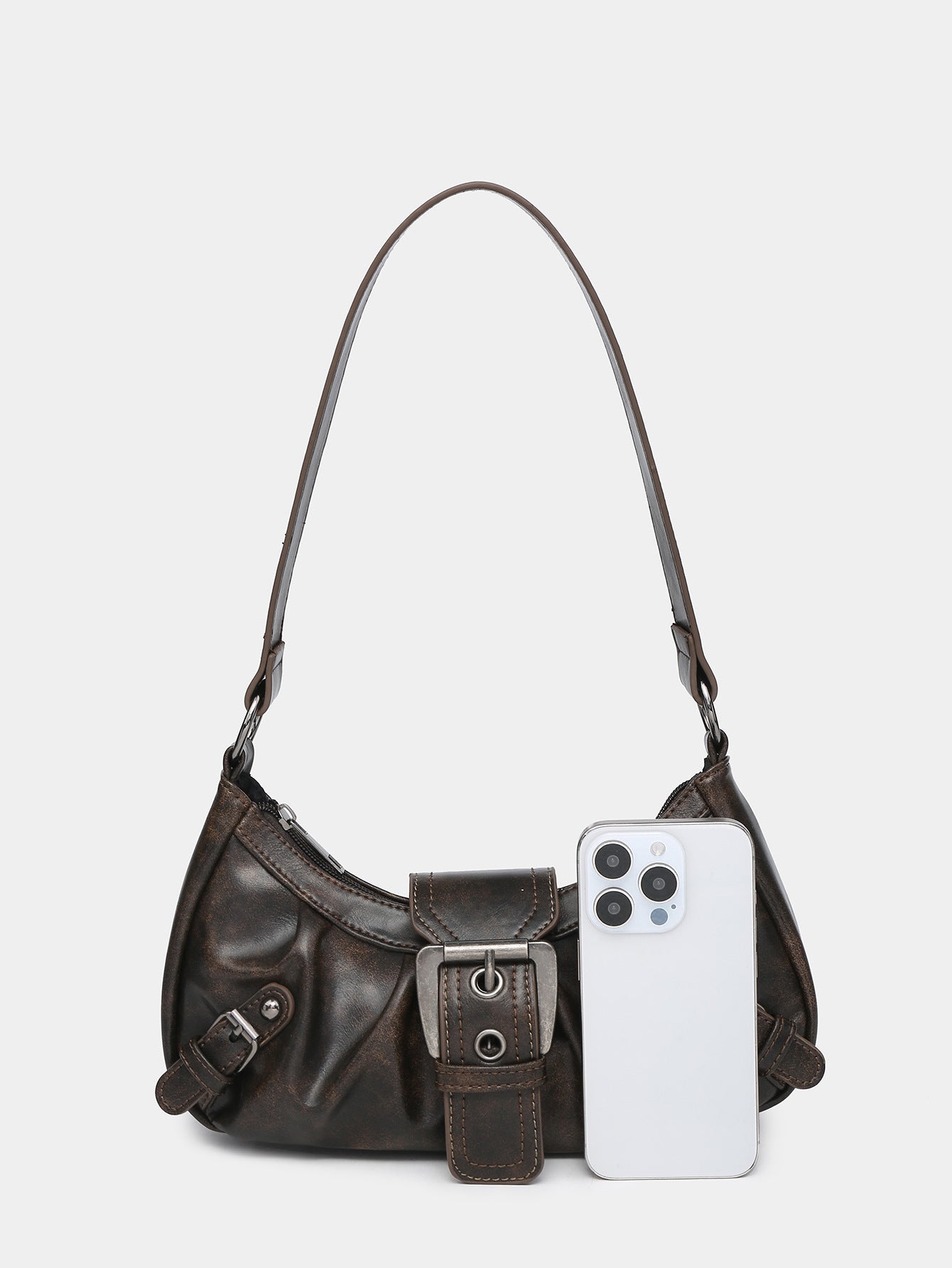 Brown faux leather hobo bag with front buckle strap; phone tucked into front pocket