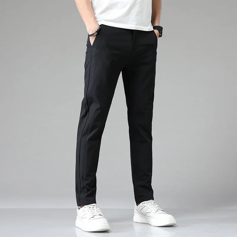 Slim-fit black pants with tapered legs and ankle-length hem