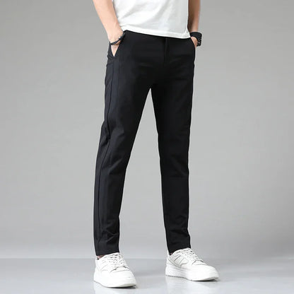 Slim-fit black pants with tapered legs and ankle-length hem