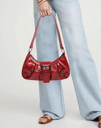 Red distressed faux leather hobo bag with front buckle and short shoulder handles