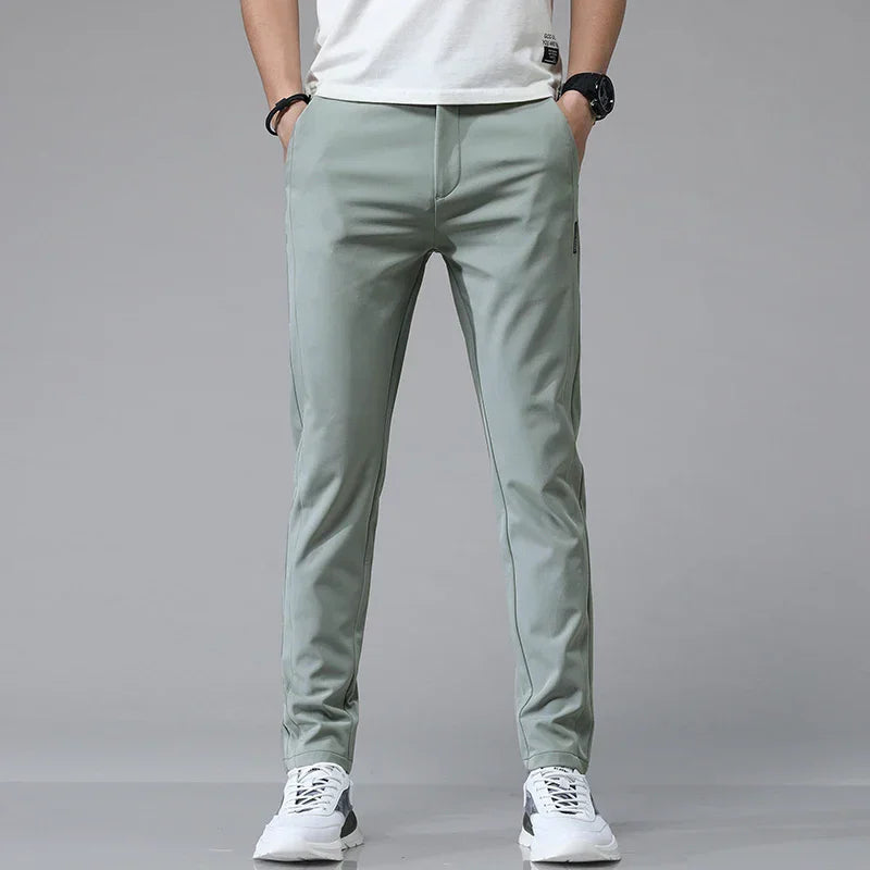 Slim-fit mint green pants with tapered legs and side zip pocket