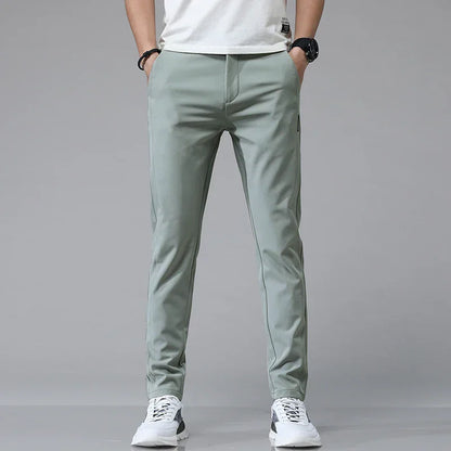 Slim-fit mint green pants with tapered legs and side zip pocket