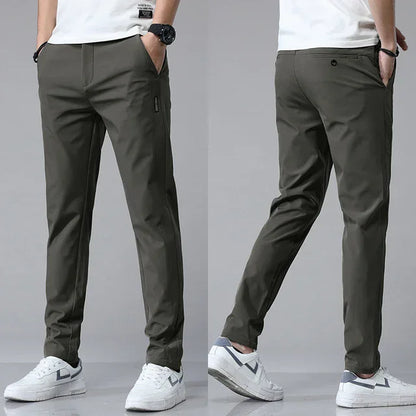 Slim-fit dark green pants with zip fly, button closure, and side pockets