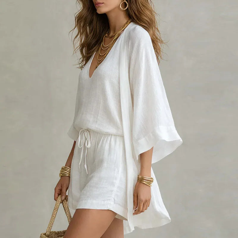White linen three-piece set with open kimono, V-neck top, and drawstring shorts