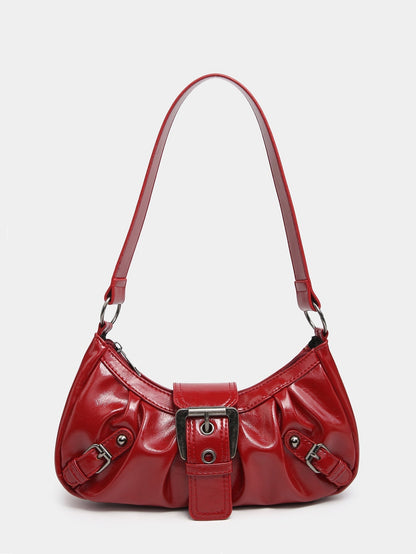 Red faux leather hobo bag with distressed look, front buckle strap, and side metal accents